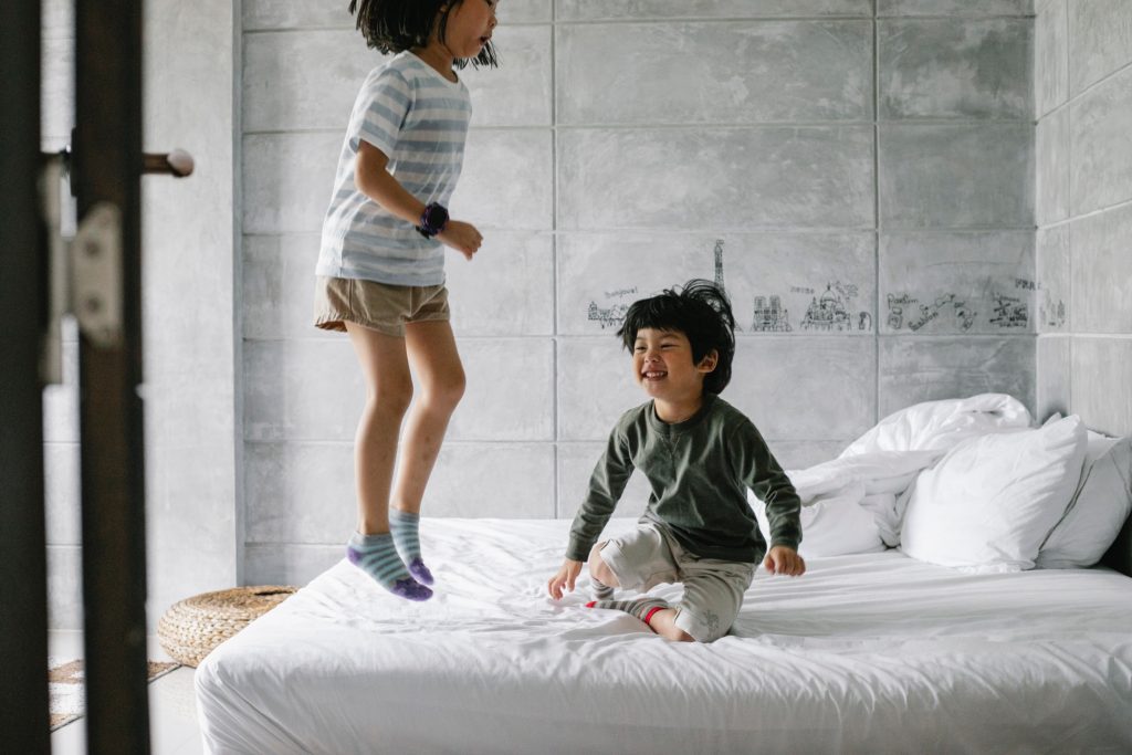 kids jumping in bed